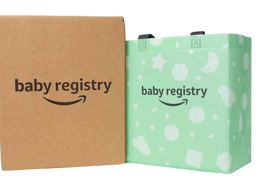 Amazon baby welcome box kit - image is of a cardboard box on the left saying "baby registry" with the Amazon smile brand mark below it. To the right is a teal-green small reusable bag with the same "baby registry" and Amazon smile brand mark below it.