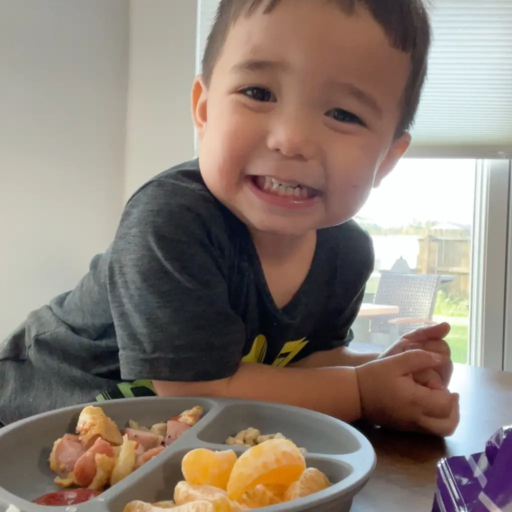 William, a toddler, enjoying an at-home meal